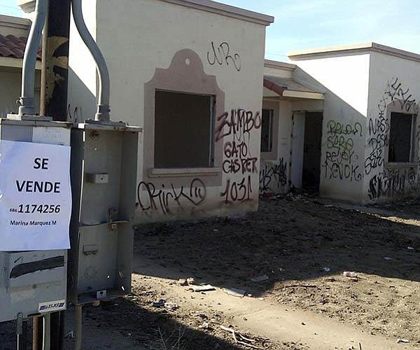 Unable to make payments, owners have abandoned homes like these across Baja.