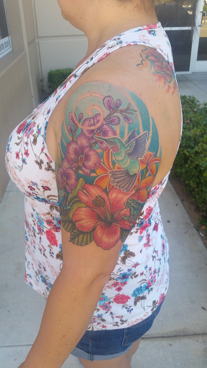 At Natures Best. My tattoo creation was created by an amazing Tattoo Artist by the name of Jon Leighton, who does amazing color and has tons of creativity. He works at Armored Ink Tattoo. I chose flowers as beauty, frogs as a new start in life and a humming bird for our loved ones who look down on us.