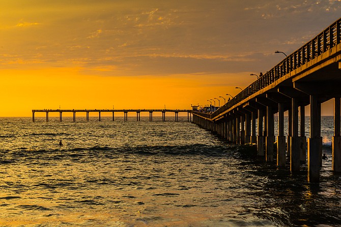 A vibrant tropical sunset at Ocean Beach Pier