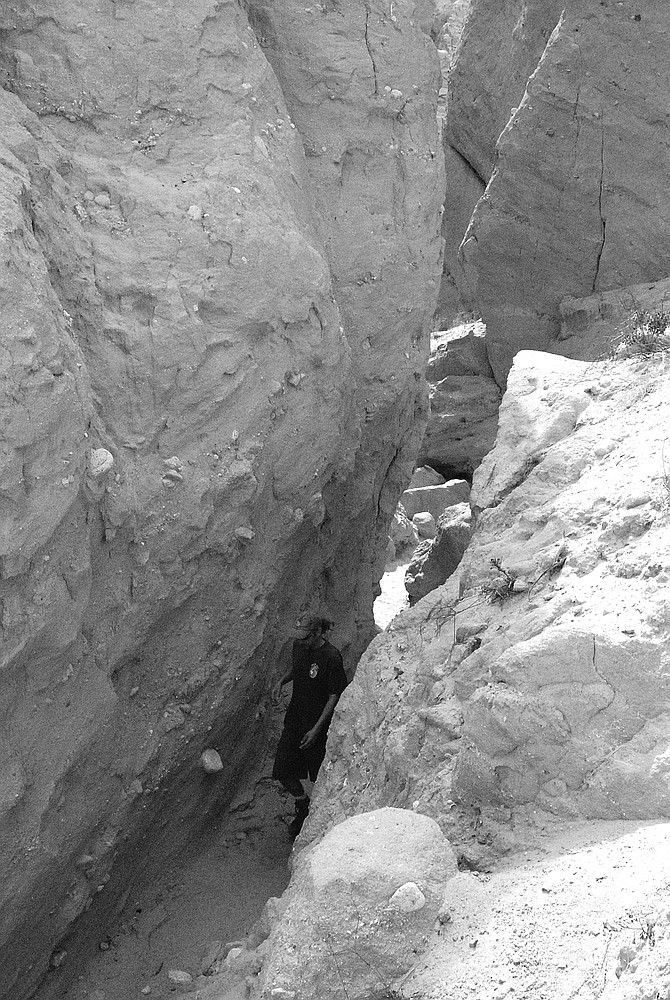 Slot canyon. At the mouth of the slot canyon, the hills had taken on a gothic appearance - ribs and spires and columns, buttresses, arches.