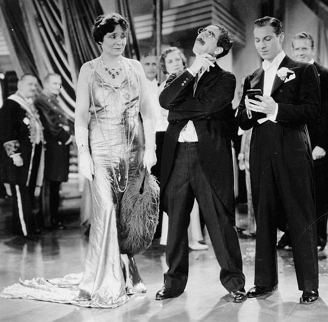 The perfect foil, Margaret Dumont, takes heat from Groucho and Zeppo.