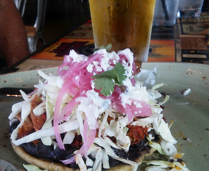The Achiote Puffy Pork Taco, overwhelmed by red onion