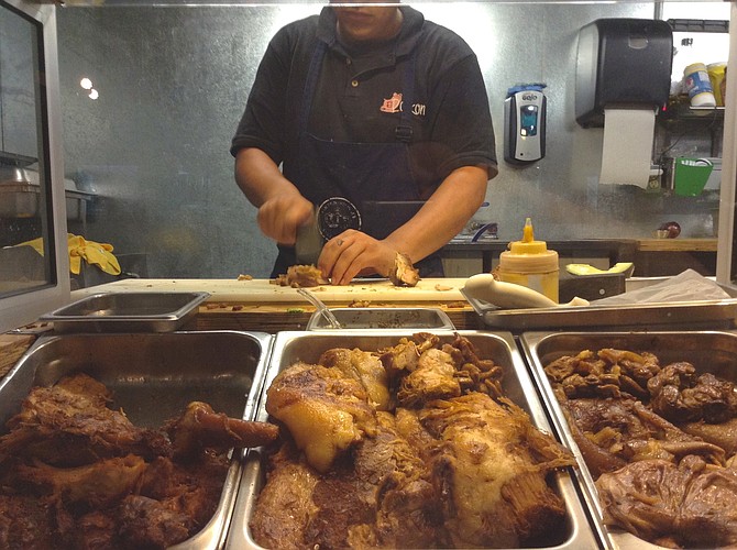 The taquero cutting pork