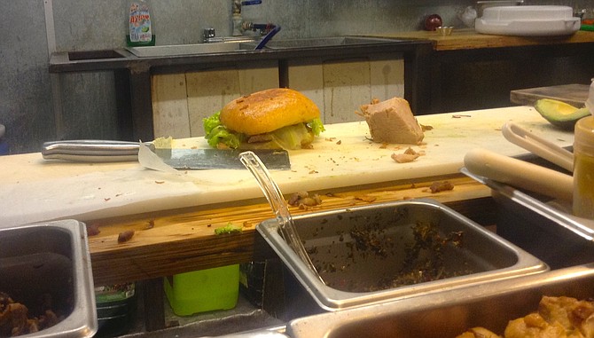 The sandwich in the kitchen, next to a big piece of maciza