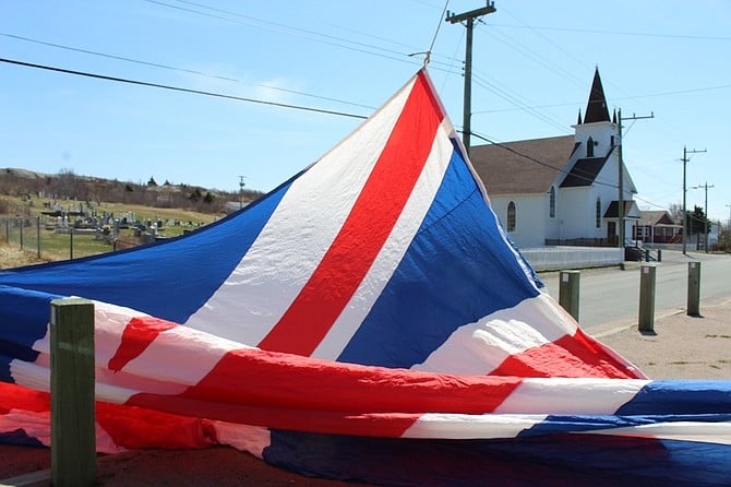 Giant Union Jack flag being unfurled in Cupids.