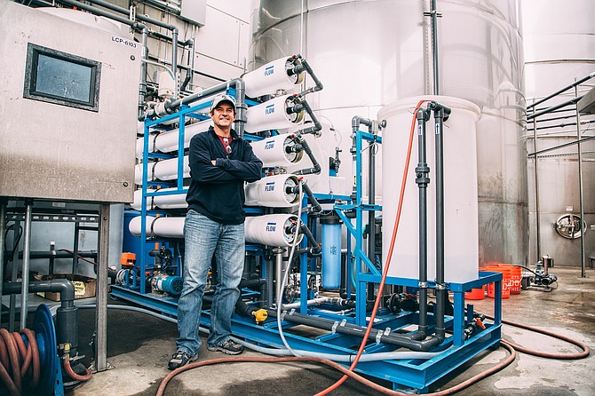Stone Brewing's Senior Water Operations Manager, Tim Suydam, stands before some of the brewery's water recycling equiptment.