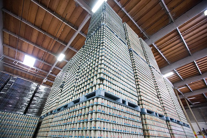 Cans of Ballast Point beer stack high in it's Miramar production facility. The brewery estimates it will sell four million cases this year.  - Image by Andy Boyd