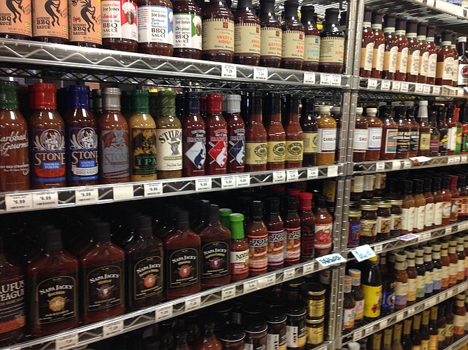 Racks filled with barbecue sauce to complement the main attractions