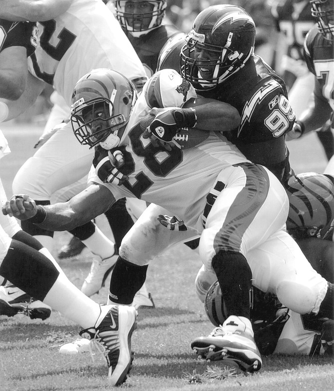 Raylee Johnson (99) in Chargers – Bengals game, 9/8/02.  A day after Diann sued Raylee, another woman filed a paternity suit against him in the same court.