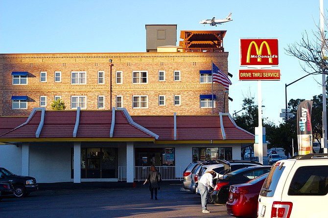 Outside view of McD's with plane arriving