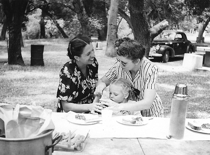 Lorraine Flippen, Judy, and Gladys, Live Oak Park, 1948. Lorraine’s face is blurred with happiness, and Gladys looks efficient and capable, leaning over Judy to scoop something out of a jar.