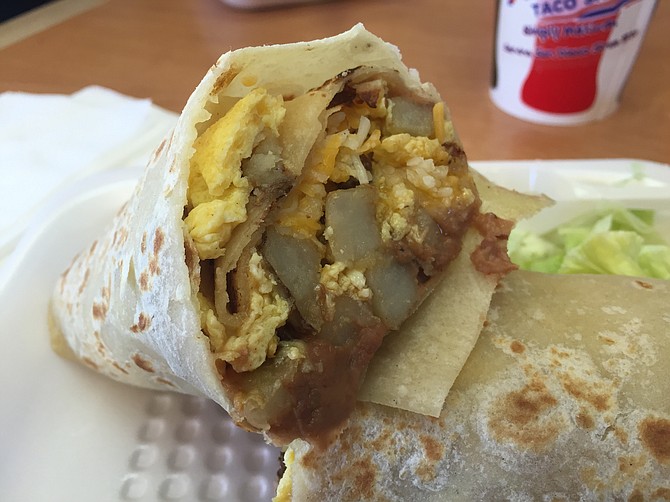 Breakfast burrito with scrambled egg, potato, cheese, and beans
