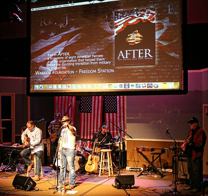 Greg White Jr. points out to SGT Toran Gaal during his debut performance of "Fullest Life" and the book trailer reveal to "After". "Country at the Grand" in support of Homes for Our Troops.

Photo by Greg Nickel, Gg Images