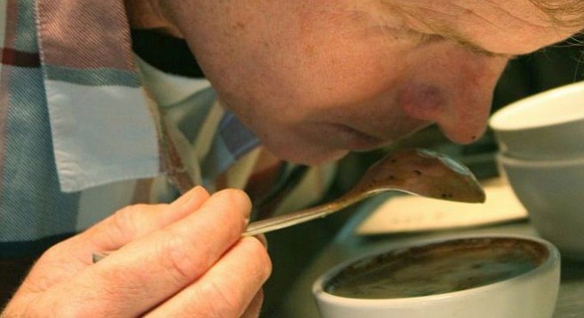 Bird Rock owner Chuck Patton examines a coffee’s aroma during a cupping.