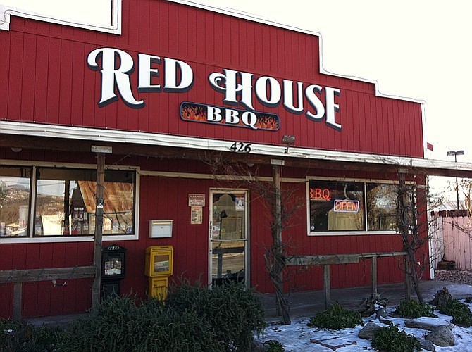 Snow lines the outside of Red House BBQ on a cold, sunny December day.