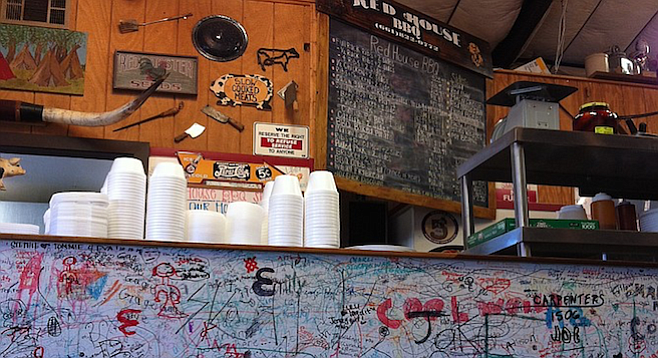 Graffiti from past customers lines the counter wall at Tehachapi's Red House BBQ.