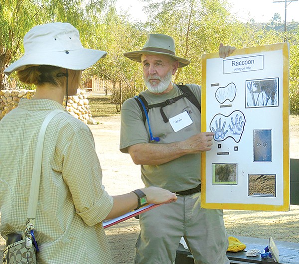 Tracking class instructor, Bob, shows how to identify raccoon tracks.