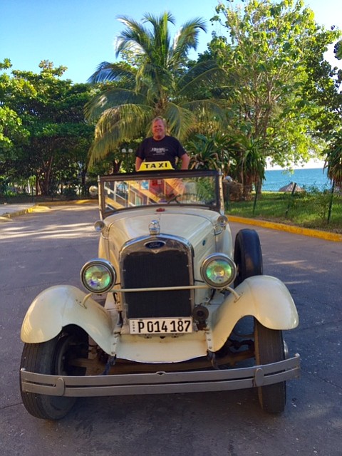 The author by the beach in a 1929 Ford.