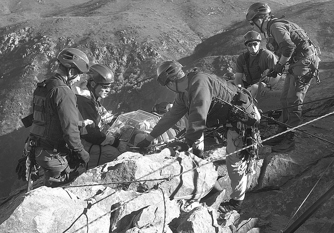 BORSTAR team during cliff-rescue training in Laguna Mountains, 12/06/02. "When we found the footprints and started following them, we kept noticing very small footprints." - Image by Joe Klein