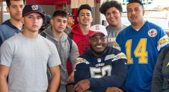 Denzel Perryman (center) flew in from Miami, went to Sweetwater High, and said, "it was so important for the Chargers to build this facility for these students.”
