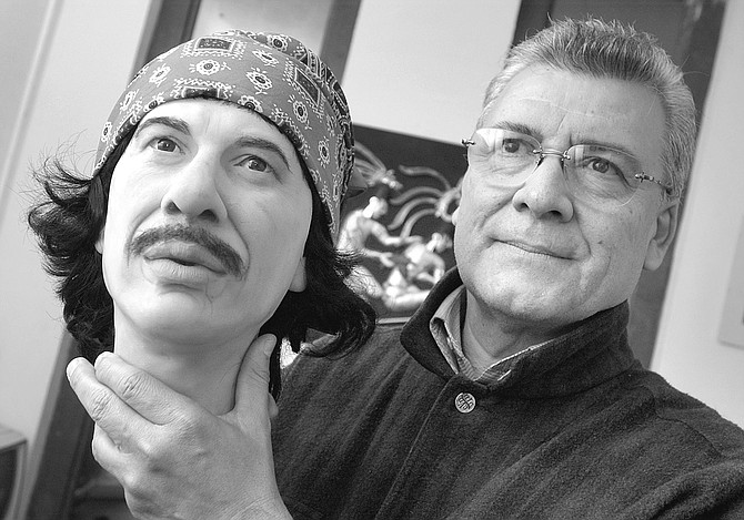 Ricardo Parra Montes holding Carlos Santana wax head.  "He's going to go over there, by the Ayatollah Khomeini." - Image by Joe Klein