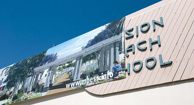 Developer’s banner on the former school’s façade advertises a video