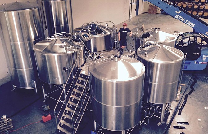 Belching Beaver brewmaster Troy Smith stands in the company's large new production facility in Oceanside.