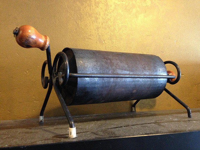 An antique campfire coffee roaster once used by the Pavaraga family to cook beans on the beaches of Hawaii.