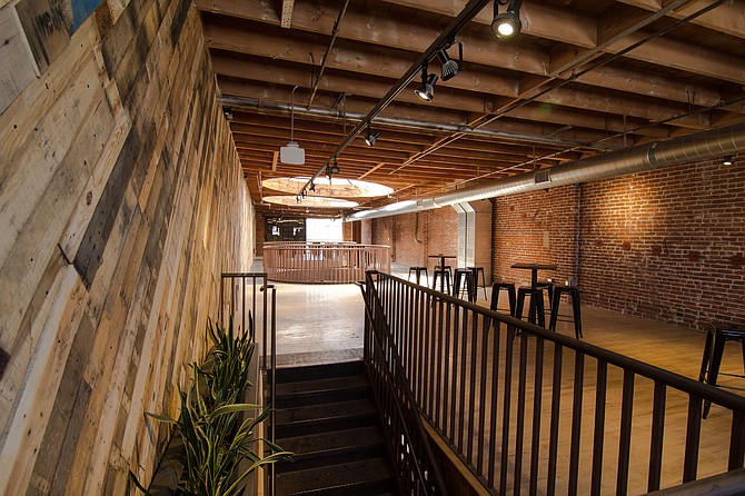 Mission Brewery's newly opened events space and tasting room expansion features exposed brick, reclaimed wood and large round skylights where grain silos used to stand taller than the rooftop.
