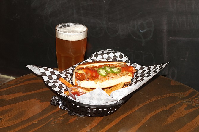 Lazy Dog and a beer. Polish sausage in an artisan bread topped with chili, onions, and jalapeños.