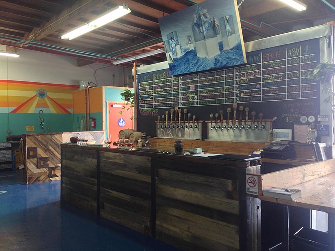 The Oceanside Brewing Company tasting room was built by its founding brewers using reclaimed wood, including a 12-foot-long bar top plucked from the Pacific Ocean.