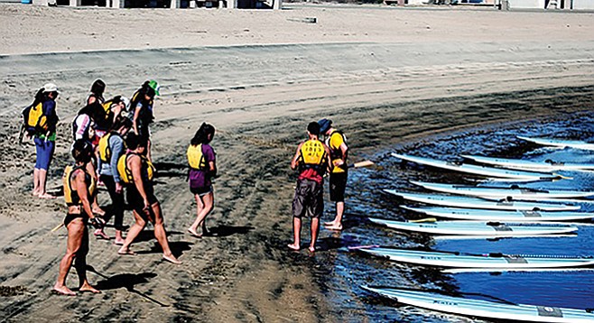 Students, mount your stand-up paddleboards (Crown Cove)