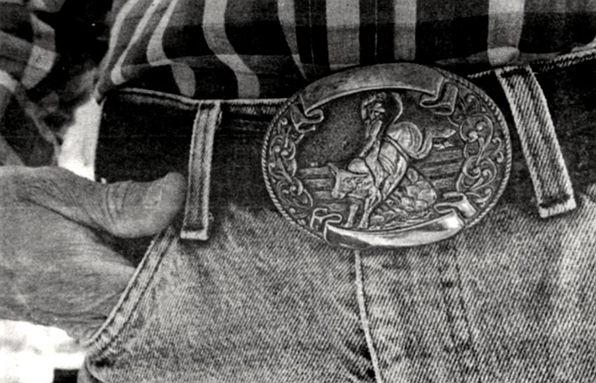 Massey's wear-faded jeans were cinched with a belt into whose bronze buckle had been cast a cowboy riding a brahma bull.