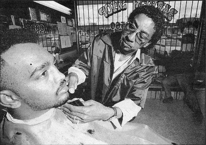Bob Coleman, Mt. Sinai Barbershop;  "That's my brother there. He was a minister, and after he died, his customers   keep coming."