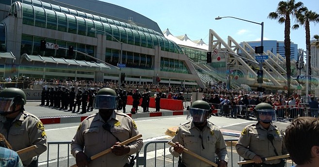 Police attempt to separate protesters from rally attendees as the convention center begins to empty