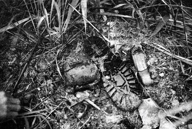 U.S. Marine's jungle boot and fragment of exploded Claymore mine