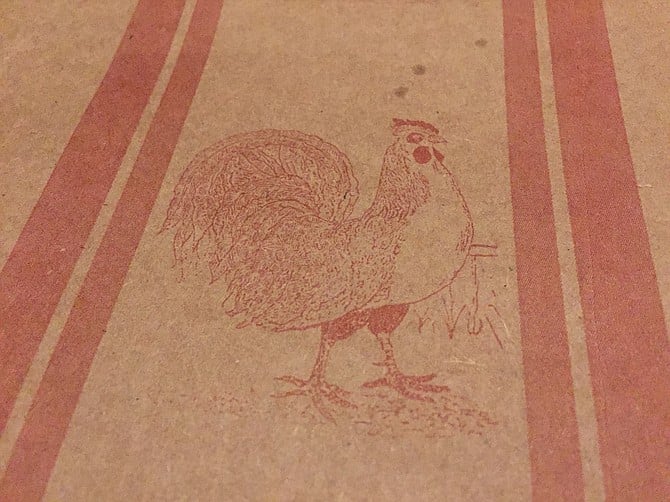 Country-themed chicken stamps on the brown paper atop each table