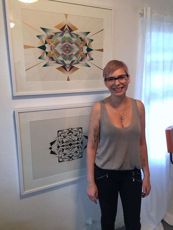 Melissa Walter with two of her pieces in the current exhibit, A New Stellar Order.