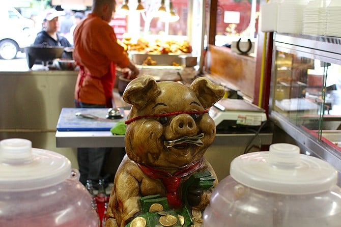 Giving change to the pig for good luck (and then the cook’s tip jar)