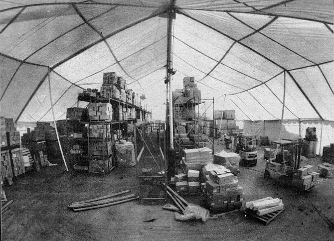 The tent and a fleet of sixty storage trailers hold completed computers and the electronic components from which they are built.