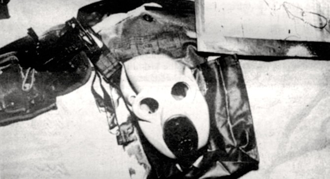 Nuclear-biological-chemical mask. "The stuff is still coming into our railroad depot on flatcars." 