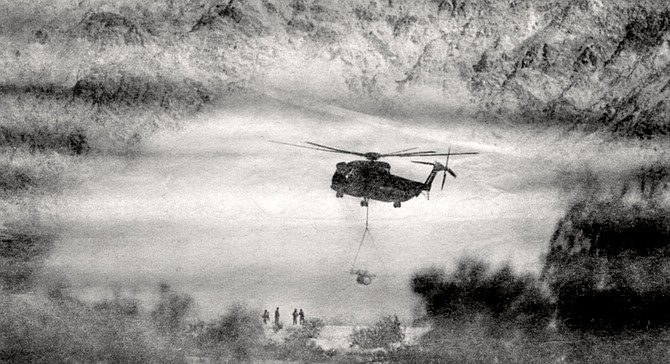 CH-53 marine helicopter airlifts a cannon. What we have allowed to happen is an insult to nature. - Image by Robert Burroughs