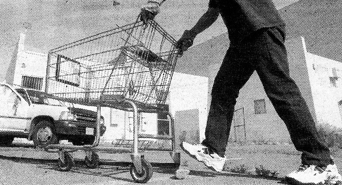  Eddy tells me this man separates the carts by store for Eddy. In return, Eddy brings him cheeseburgers. - Image by Sandy Huffaker, Jr.