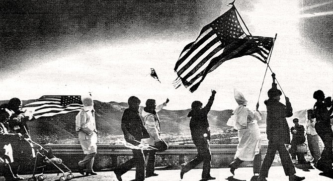 Klan members greeted by hecklers on their march to San Pasqual monument, January 20, 1980. Metzger staged a commemoration of Kit Carson, a man he praised for his valor against Mexican soldiers.