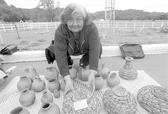 Gloria Castañeda. When her relative Petra started making baskets, sumac was the weft, and the bundle was made of deer grass, but the overgrazing of the late 1800s took away the deer grass. - Image by Sandy Huffaker, Jr.
