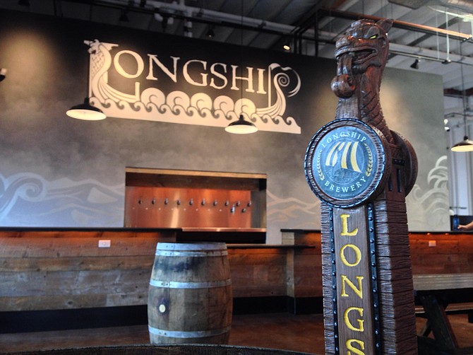 Hand-carved tap handles resemble the dragons on the bows of Viking vessels at Longship Brewery.