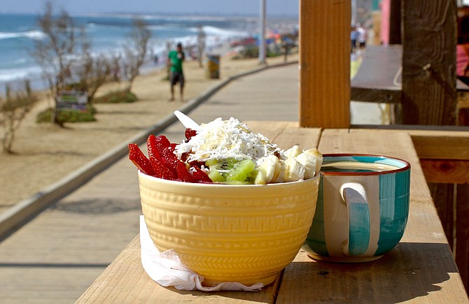 Tropical açai bowl and coffee with ocean view