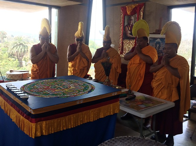 The Monks of Gaden Shartse Phukhang Monastery praying before the dissolution of the sand mandala
