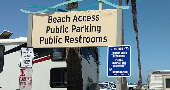 The signage alludes to the fact that beachgoers are under police surveillance