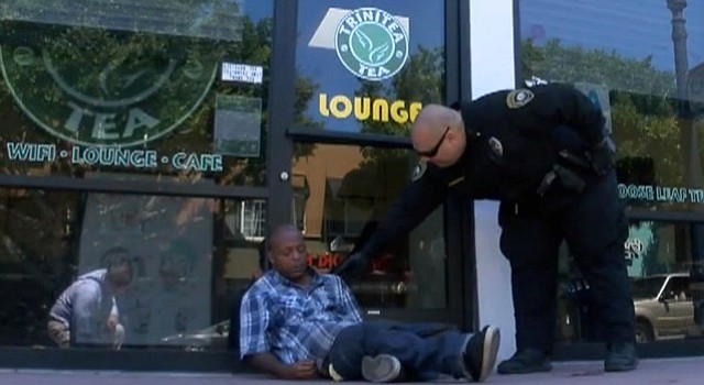 “But the sign says ‘Lounge’!” A member of the Boys in Blue private security firm hired by the Hillcrest Business Association informs a homeless African-American that he’s wandered into the wrong part of town, and had better keep on walking if he knows what’s good for him.